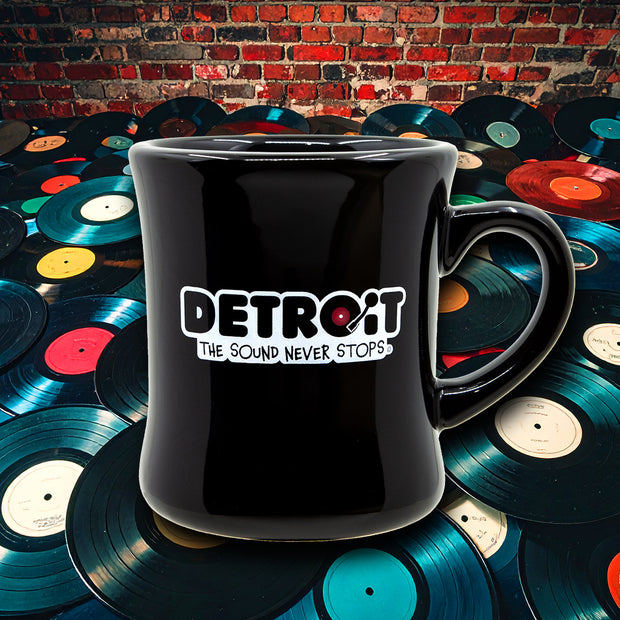 Black diner mug with 'Detroit: The Sound Never Stops' highlighting Motown and Detroit music