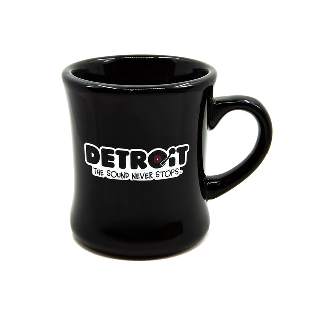 Black diner mug with 'Detroit: The Sound Never Stops' text on a white background